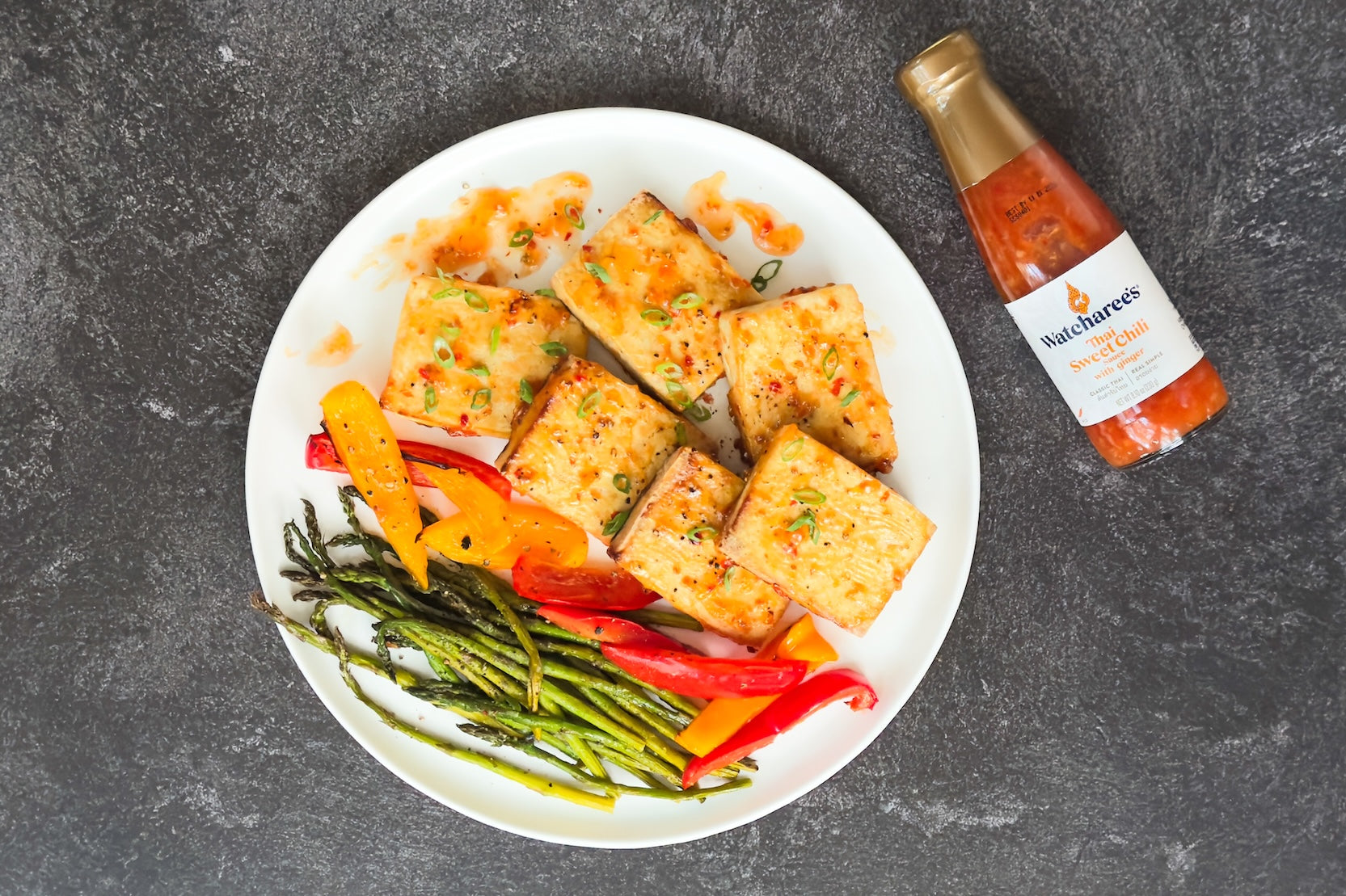 Air fryer tofu with asparagus and peppers in sweet chili ginger sauce. A quick, healthy vegan Thai dinner ready in 20 minutes.