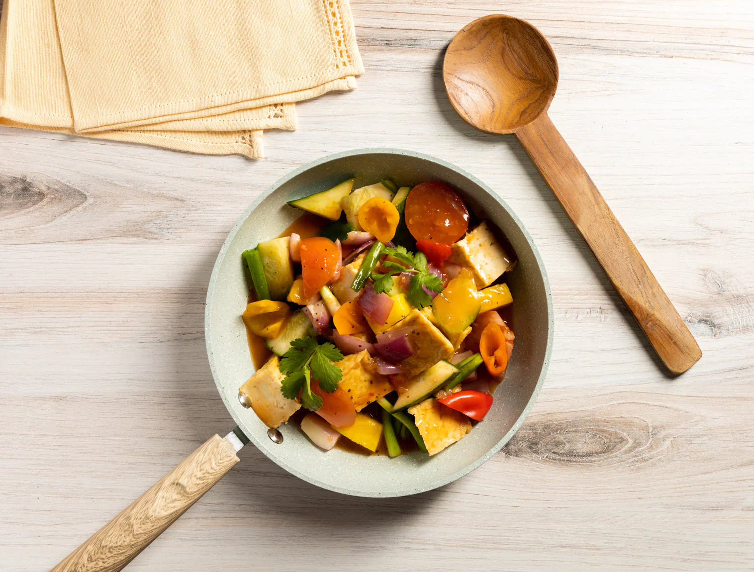 Thai sweet and sour tofu stir fry with pineapple, cucumber, tomatoes, bell pepper, and Watcharee’s Thai Sweet & Sour Sauce.