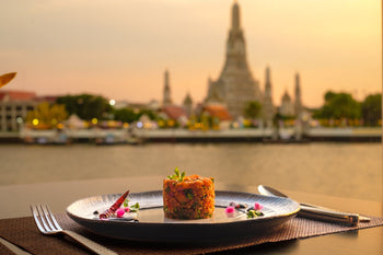Wat Arun Bangkok temple with food dish in front
